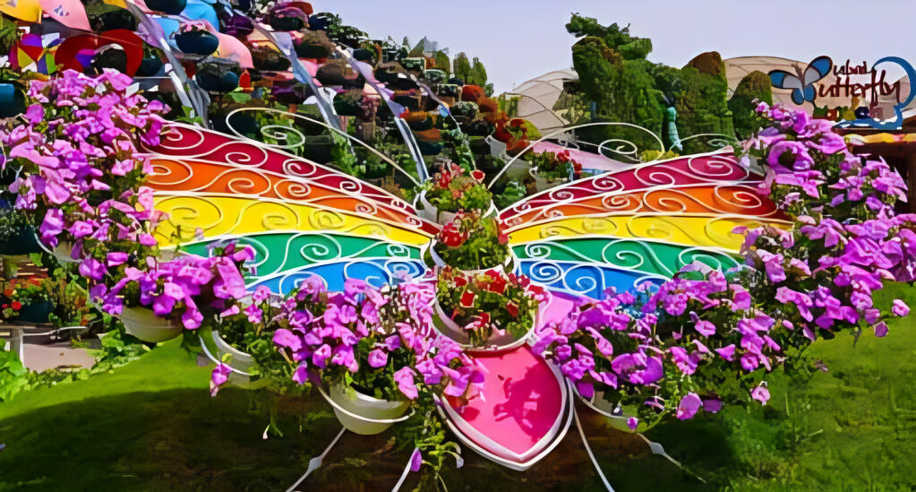Colorful butterfly-shaped flower installation at Dubai Butterfly Garden, surrounded by vibrant blooms and creative garden decor.