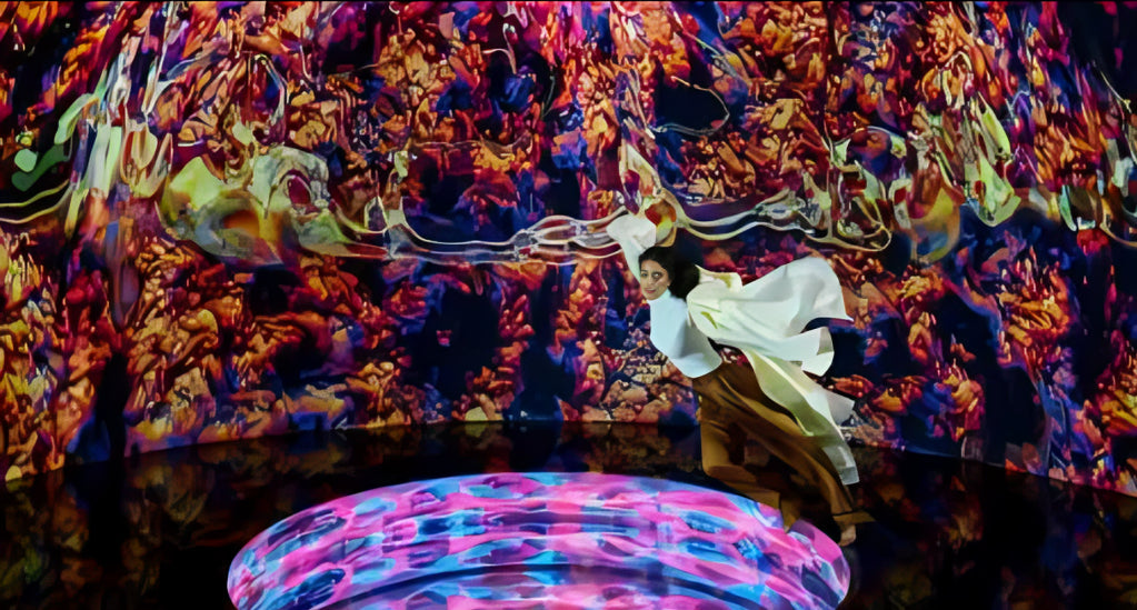 Woman posing in a vibrant, interactive room with dynamic digital art projections at AYA Universe Dubai.