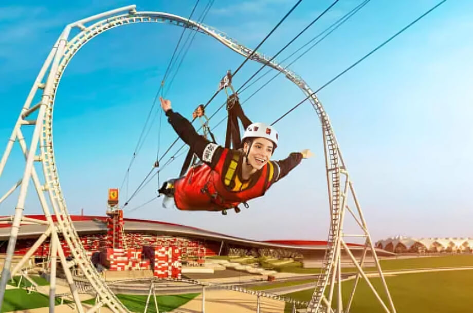 Visitor enjoying the flying zipline experience at Ferrari World Abu Dhabi, soaring above Yas Island’s iconic red-roofed attraction.