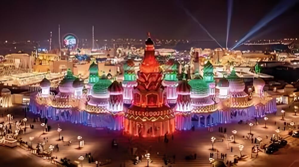 Colorful night view of Global Village Dubai, featuring illuminated pavilions inspired by world architecture and bustling cultural attractions.