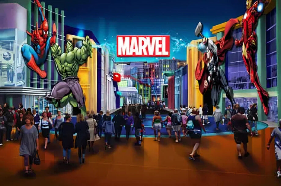 Crowds entering the Marvel,Lost Valley attractions at IMG Worlds of Adventure Dubai, surrounded by giant superhero displays of Hulk, Spider-Man, Thor, and Iron Man.