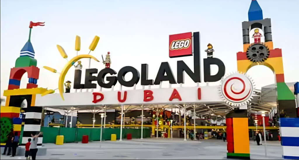 Colorful entrance of LEGOLAND Dubai Park featuring giant LEGO brick structures and themed decorations for family fun.